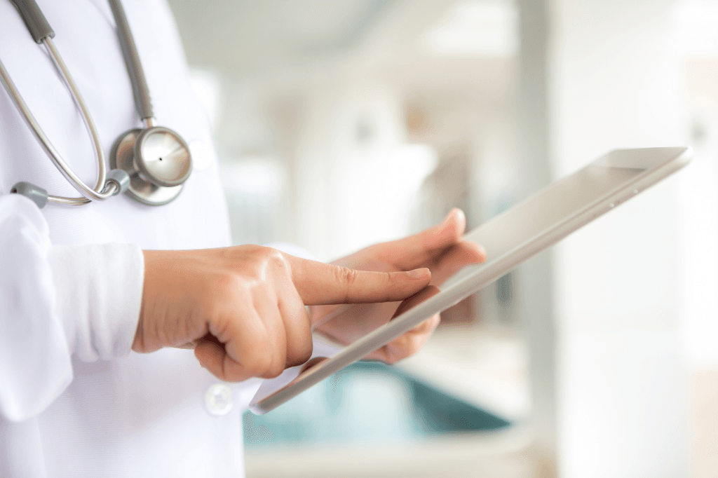 Clinician using a tablet on a ward